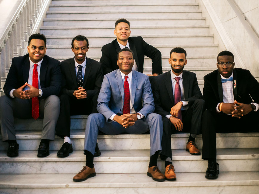 Group of Scholars in suits sitting on stairs. Group of Scholars in suits sitting on stairs.