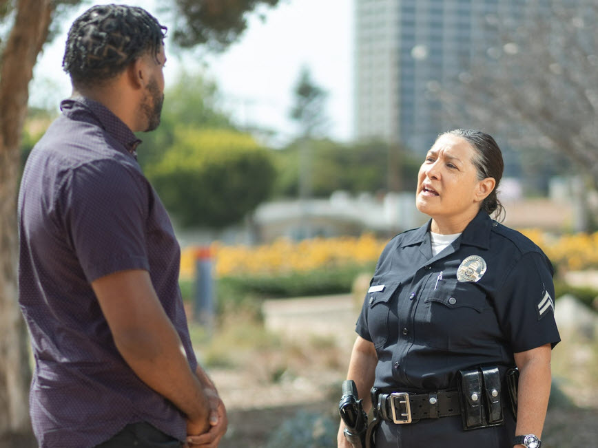 Police talking with a man outdoors Police talking with a man outdoors